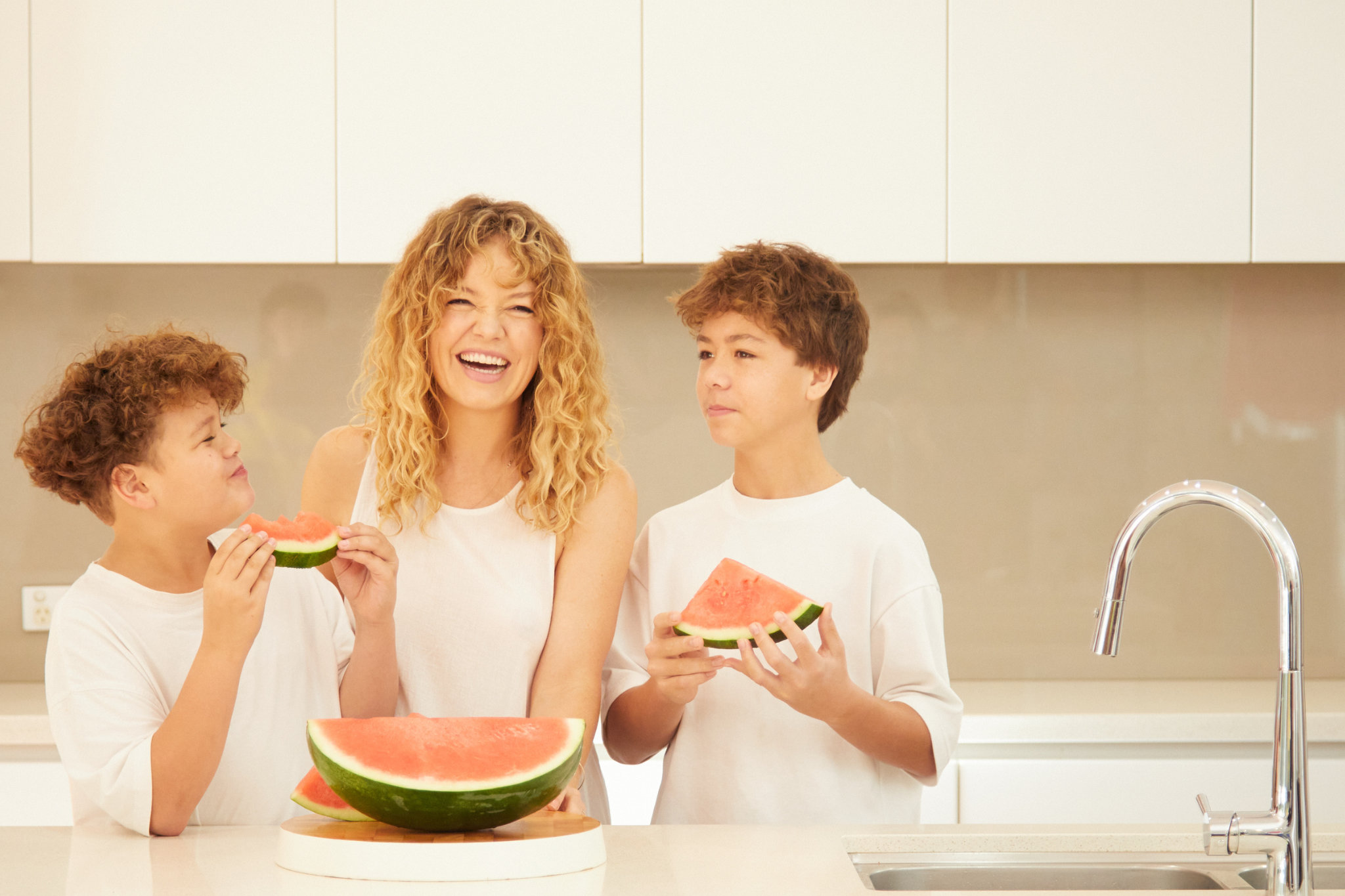 W2W-FAMILY-EATING-WATERMELON-IN-KITCHEN