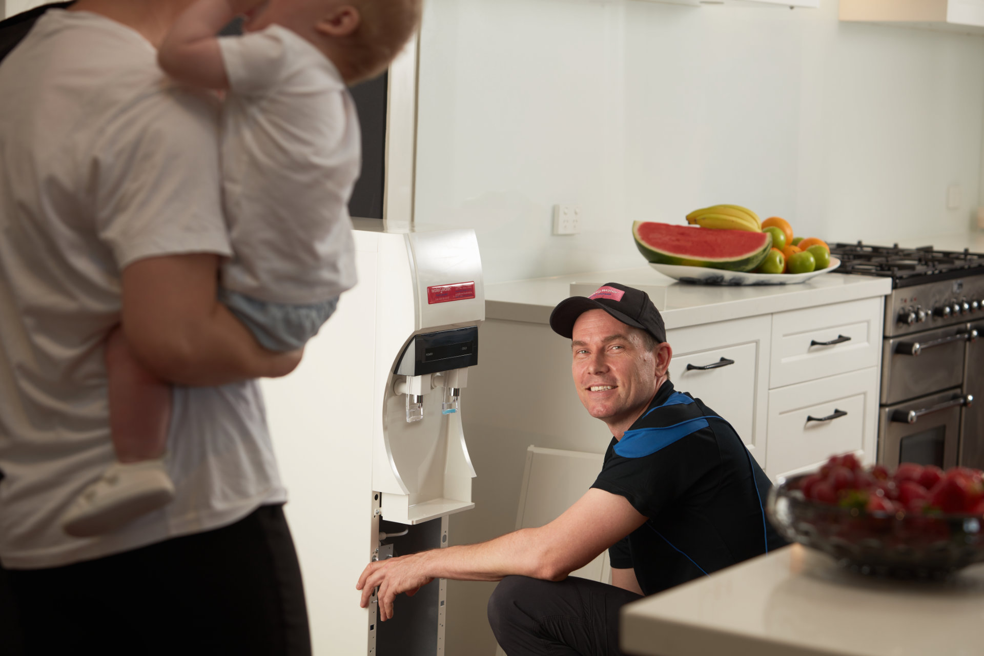 W2W-Water-Filtration-Technician-Servicing-Water-Cooler-in-Customer-Kitchen